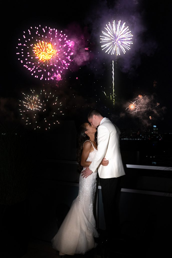 Joye and Scott Wedding - Bride and Groom Kissing Fireworks - Tribeca Rooftop - Rafal Ostrowski Photography
