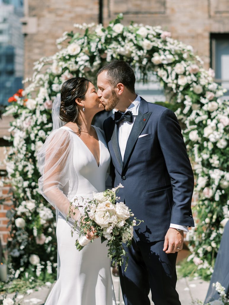 Lianne and Justin Wedding - Bride and Groom Kissing Bouquet - The Library Hotel - Liz Andolina Photography